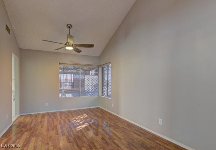 356 Amalfi Street Henderson, NV 89074 - Photo 5 of 15 Spare room featuring wood finished floors, lofted ceiling, and a ceiling fan