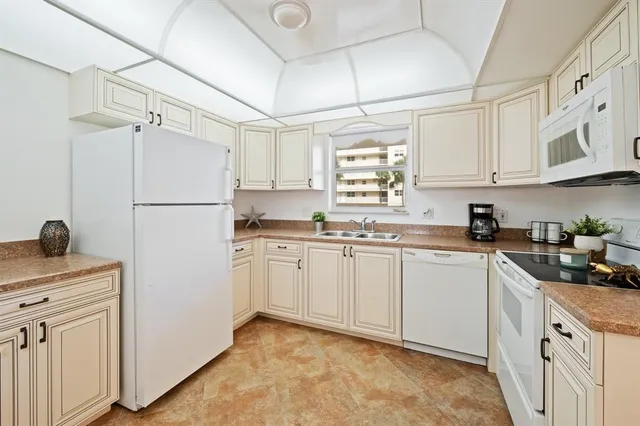 a kitchen with stainless steel appliances white cabinets and a stove top oven