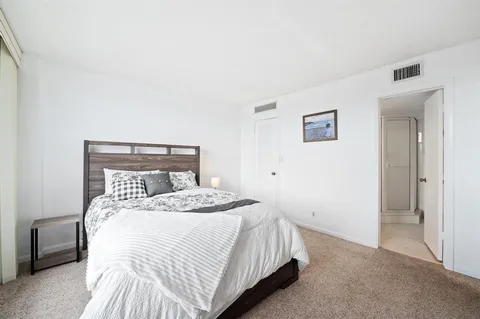 a bathroom with a shower sink vanity mirror and toilet