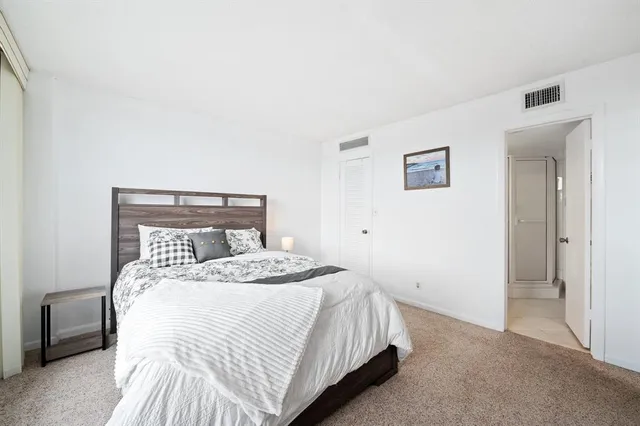 a bathroom with a shower sink vanity mirror and toilet
