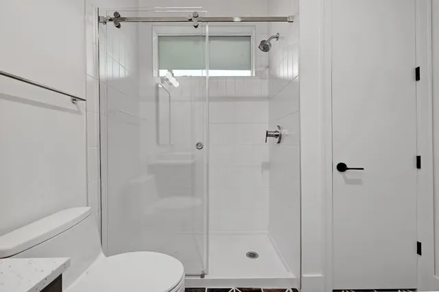 a bathroom with a shower and a toilet