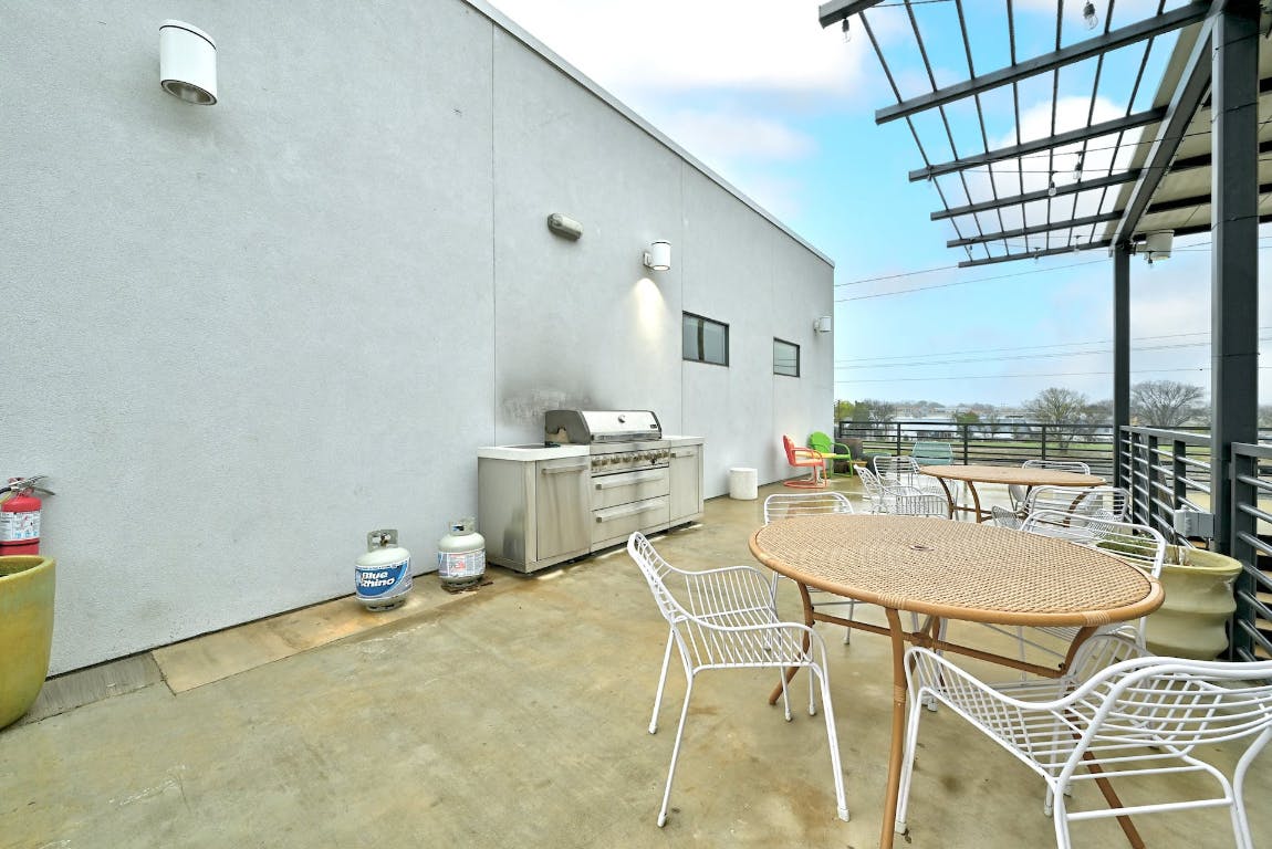 2709 East 5th Street, Unit 1303 Austin, TX 78702 - Photo 16 of 18 a dining room with furniture and a kitchen view