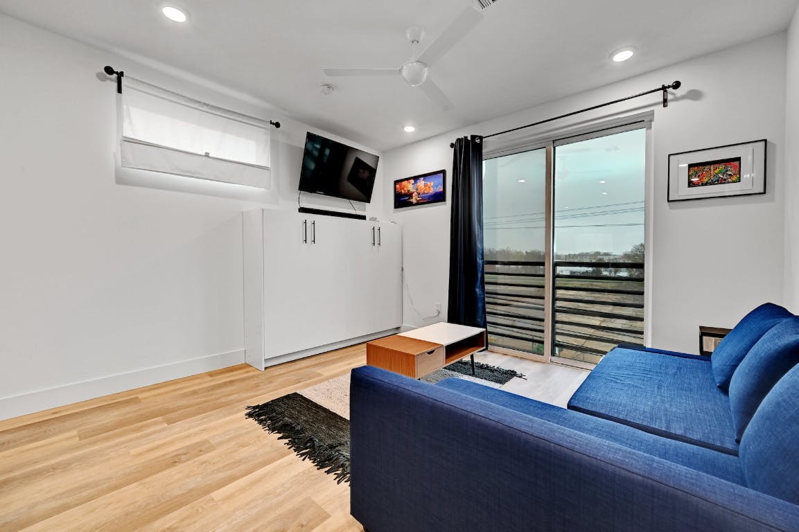 2709 East 5th Street, Unit 1303 Austin, TX 78702 - Photo 8 of 18 a living room with furniture and a flat screen tv
