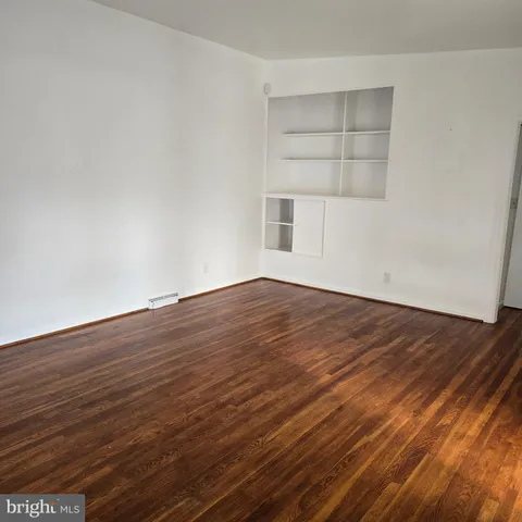 a view of a room with wooden floors and a window