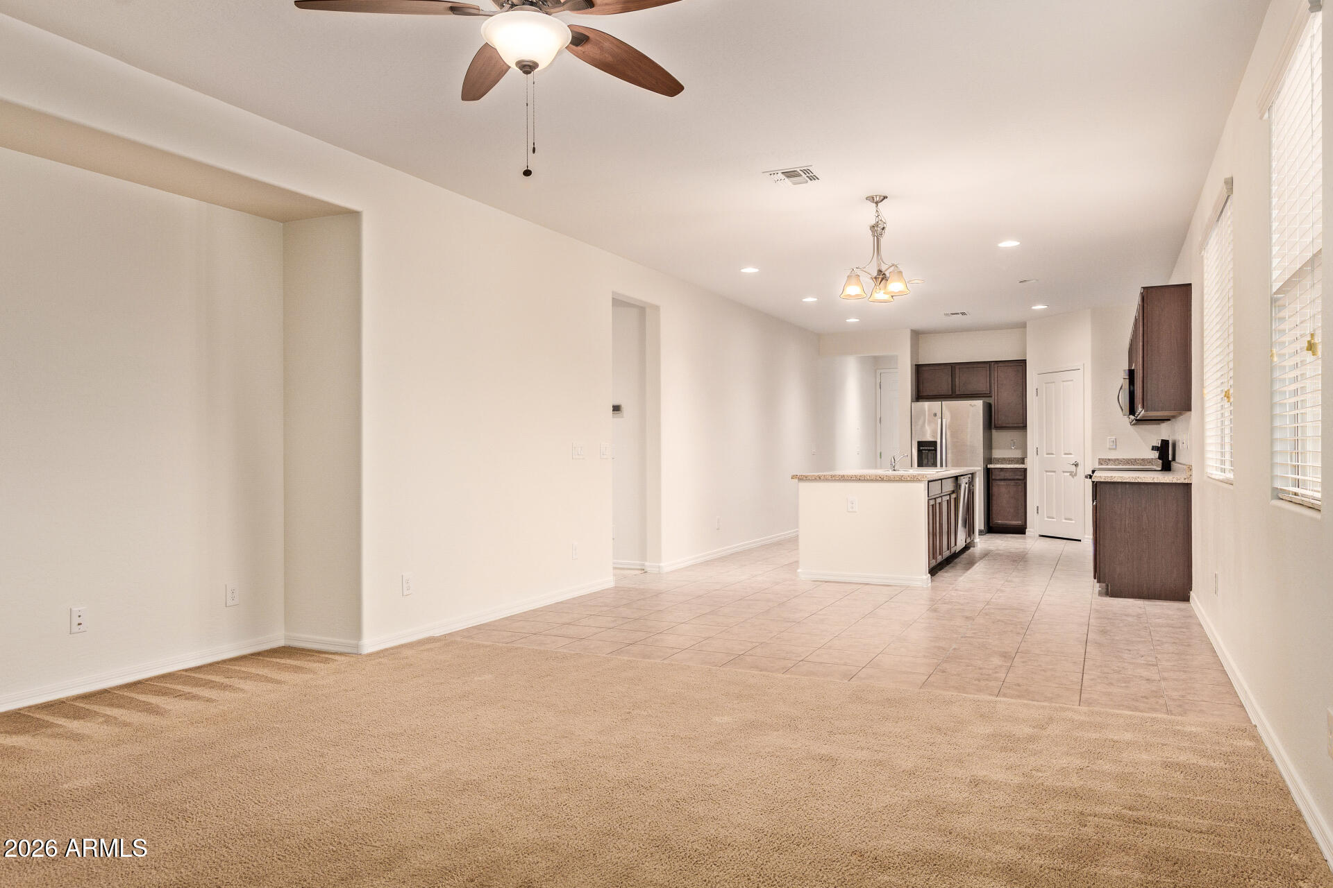 41334 West Rio Bravo Drive Maricopa, AZ 85138 - Photo 11 of 43 a view of a kitchen with a sink and a refrigerator
