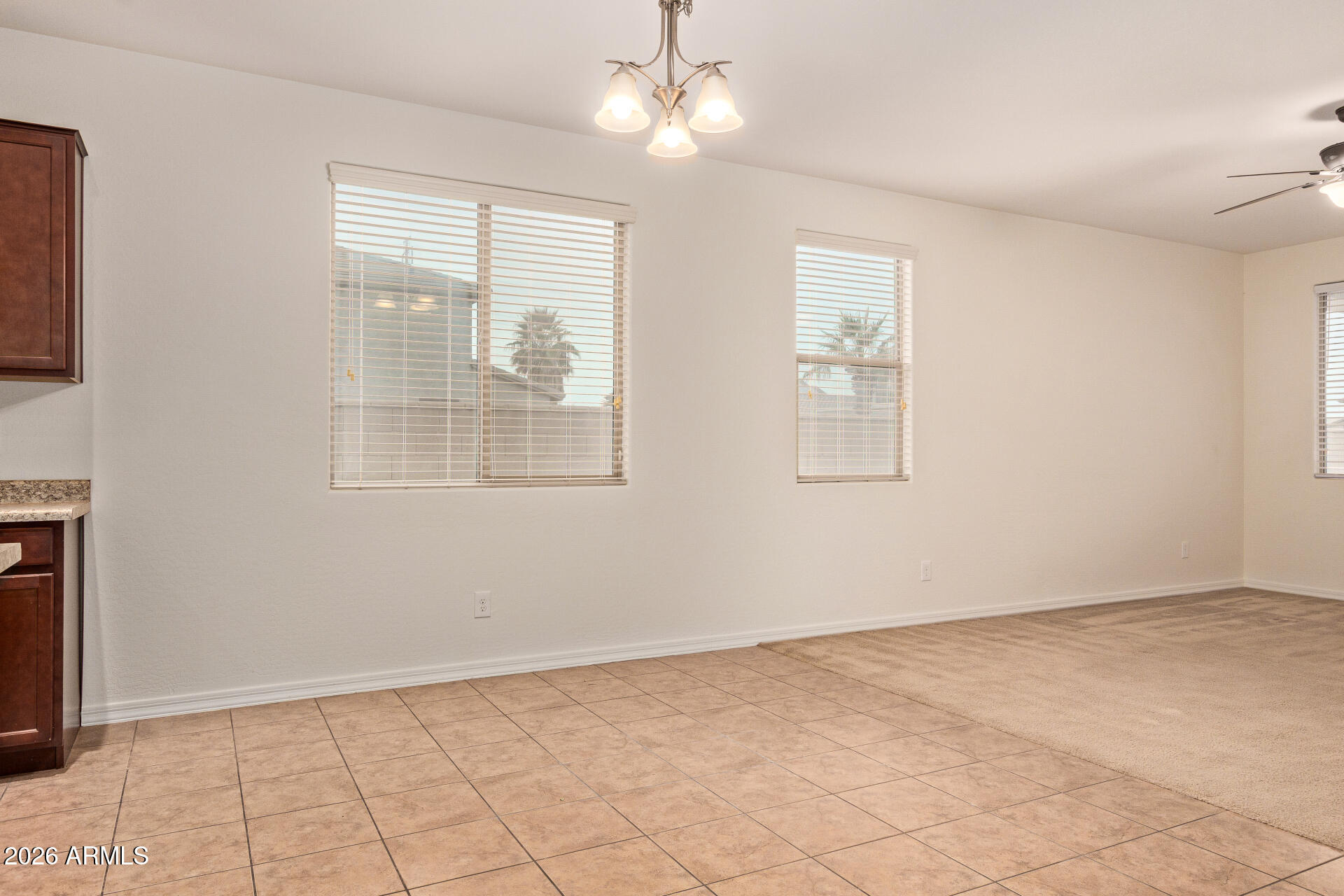 41334 West Rio Bravo Drive Maricopa, AZ 85138 - Photo 12 of 43 a view of an empty room with window and chandelier fan