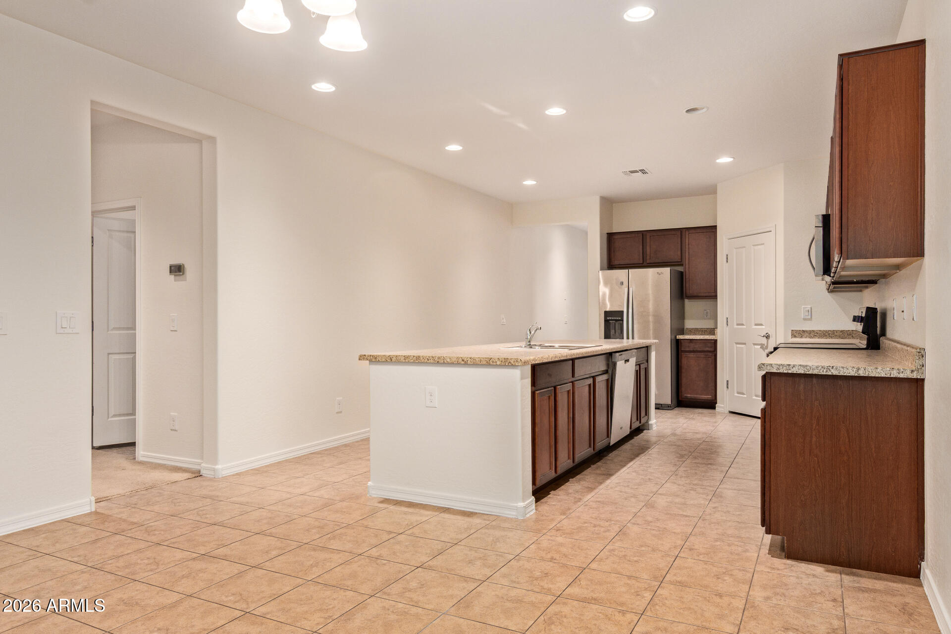 41334 West Rio Bravo Drive Maricopa, AZ 85138 - Photo 13 of 43 a kitchen with stainless steel appliances a refrigerator and a stove top oven