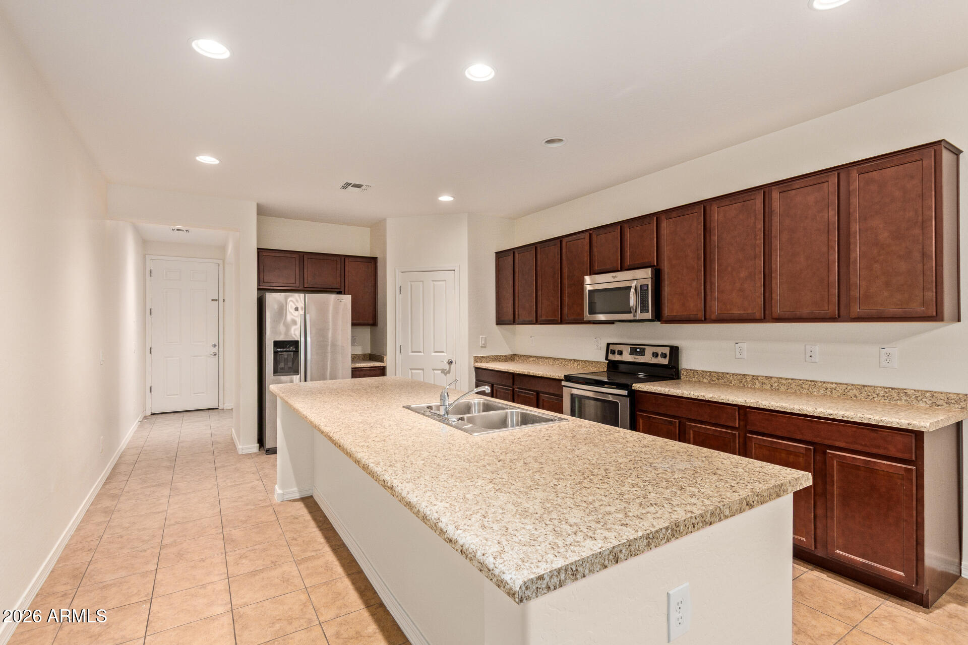 41334 West Rio Bravo Drive Maricopa, AZ 85138 - Photo 16 of 43 a kitchen with stainless steel appliances granite countertop a sink stove and refrigerator
