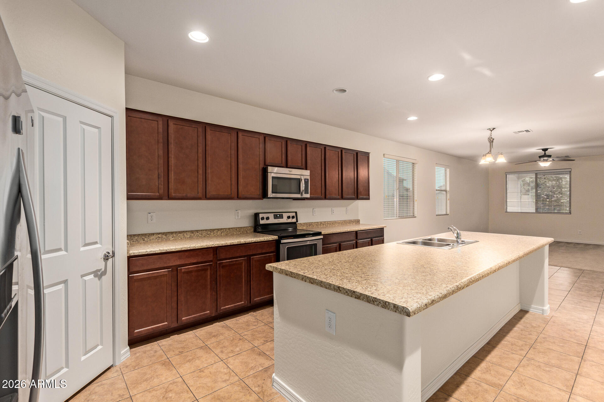 41334 West Rio Bravo Drive Maricopa, AZ 85138 - Photo 2 of 43 a large kitchen with kitchen island a sink stainless steel appliances and cabinets