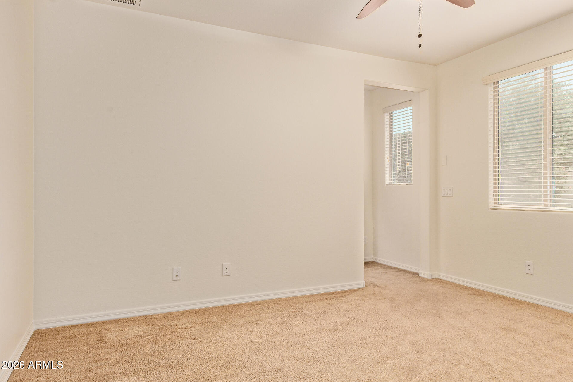 41334 West Rio Bravo Drive Maricopa, AZ 85138 - Photo 22 of 43 an empty room with windows and chandelier fan