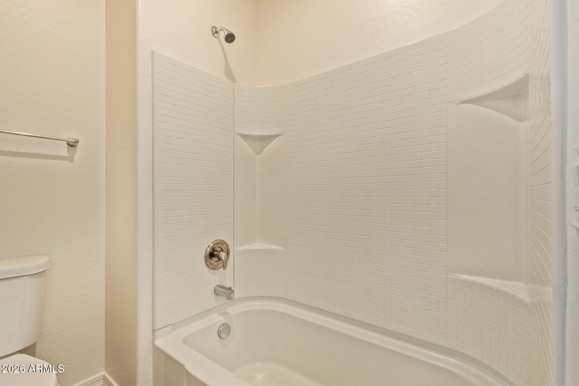41334 West Rio Bravo Drive Maricopa, AZ 85138 - Photo 26 of 43 a bathroom with a bathtub and a toilet
