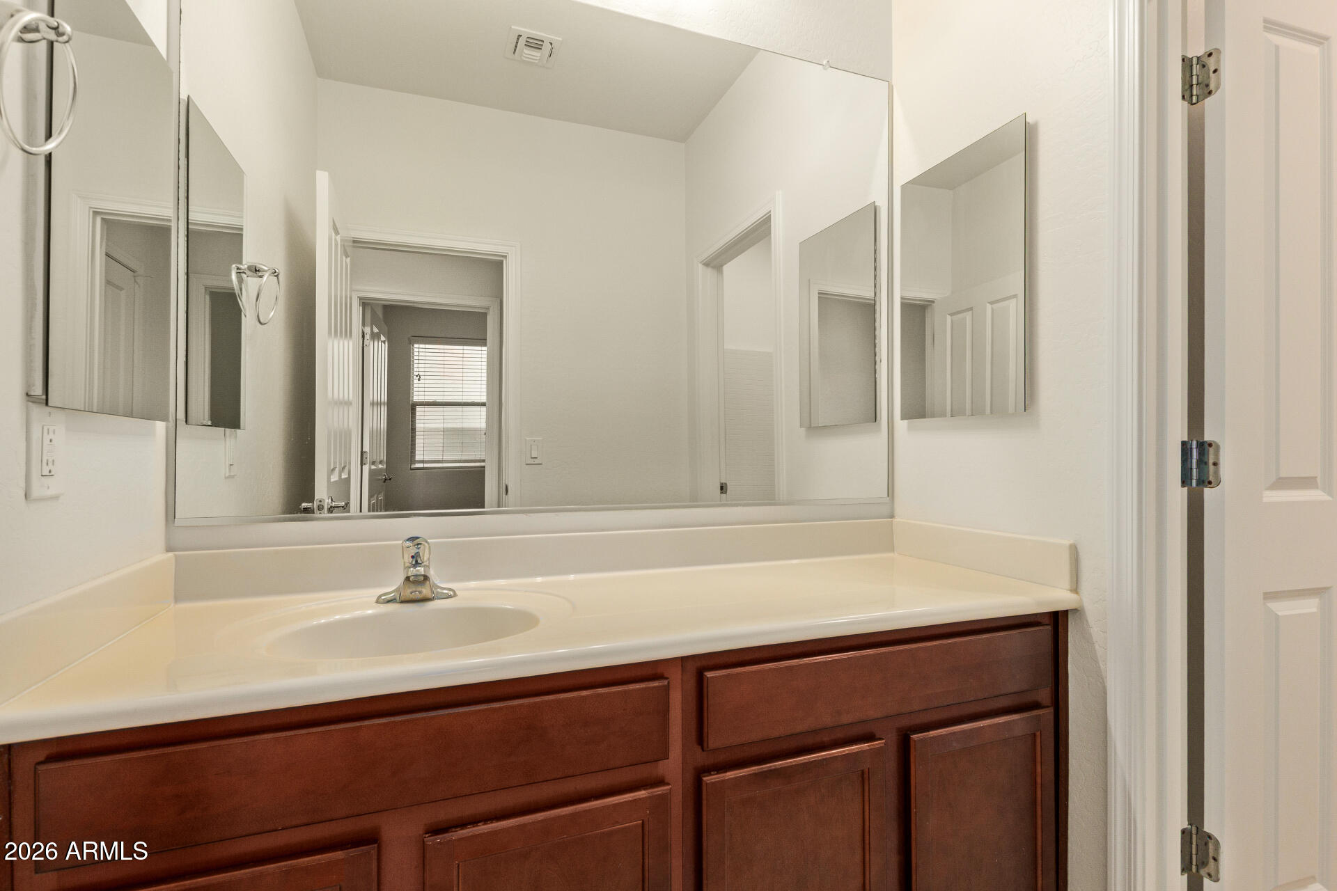 41334 West Rio Bravo Drive Maricopa, AZ 85138 - Photo 32 of 43 a bathroom with a sink and a mirror