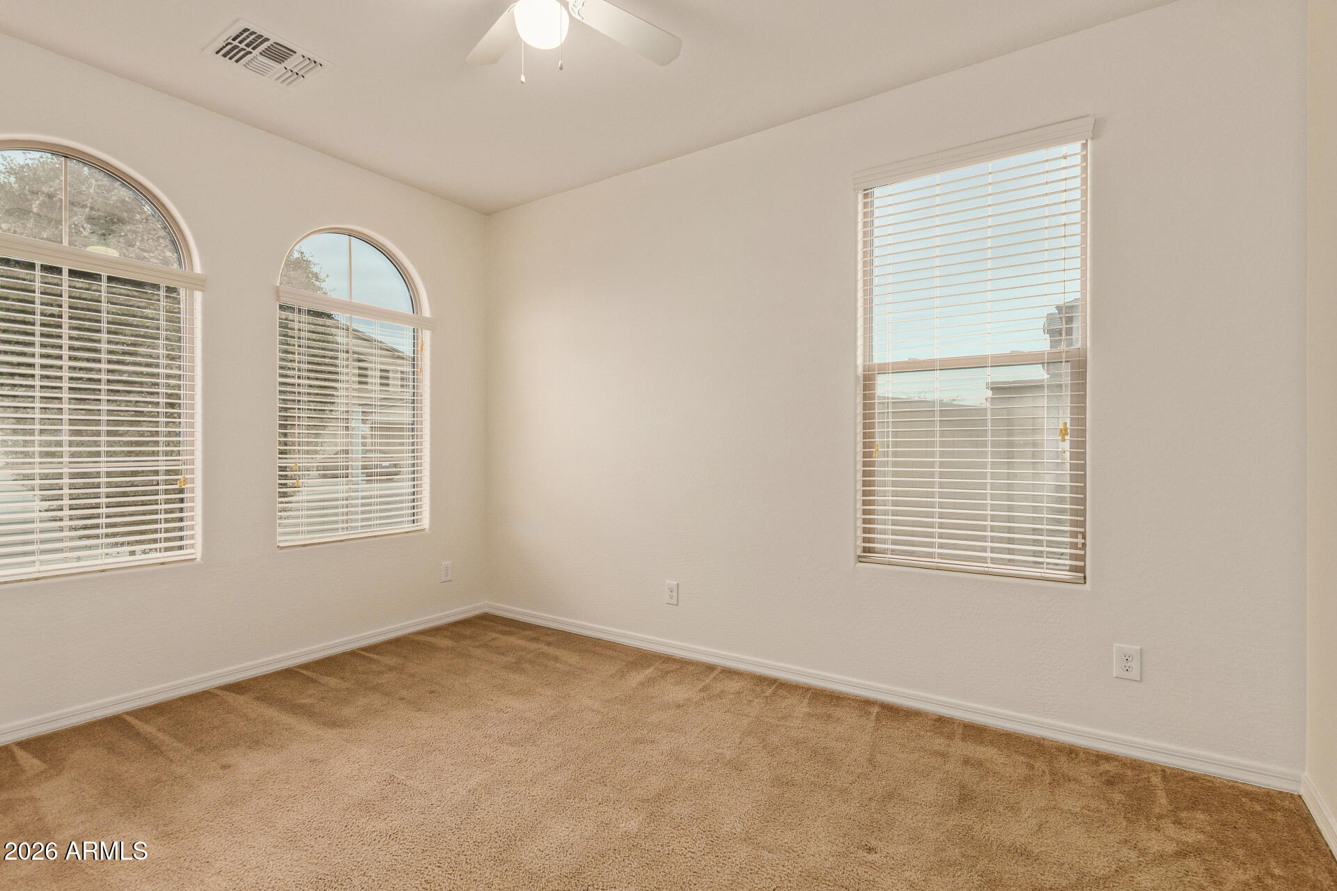 41334 West Rio Bravo Drive Maricopa, AZ 85138 - Photo 4 of 43 an empty room with windows