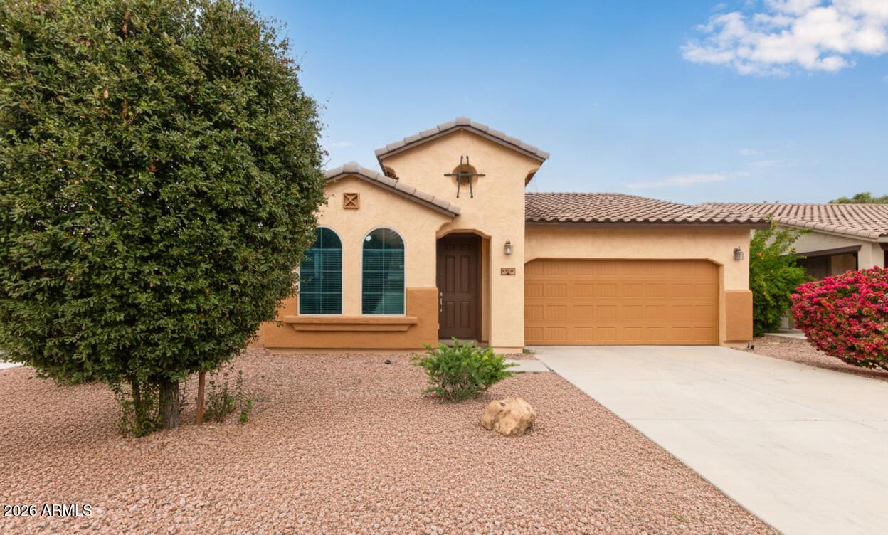41334 West Rio Bravo Drive Maricopa, AZ 85138 - Photo 43 of 43 a front view of a house with a yard and garage