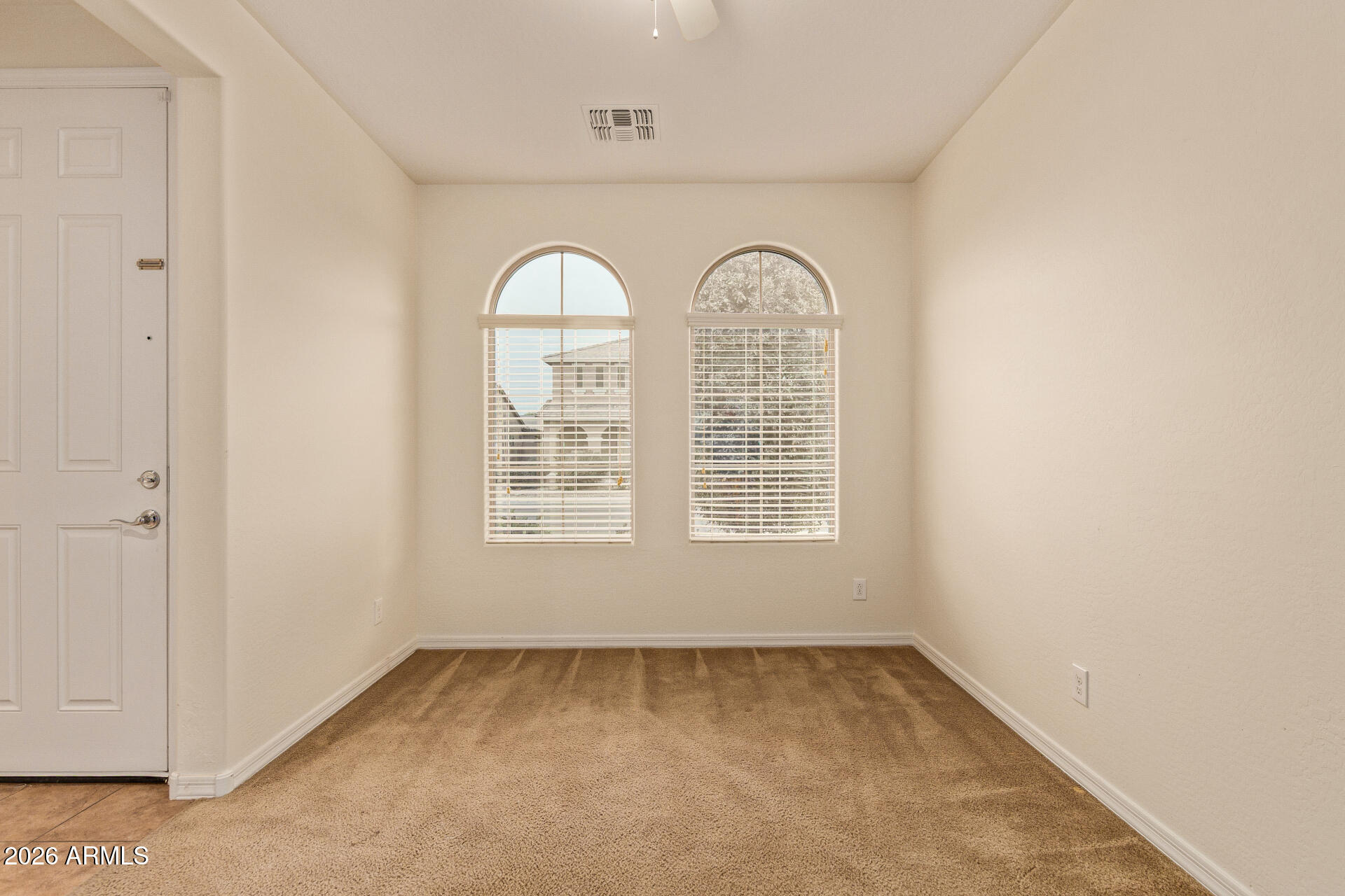 41334 West Rio Bravo Drive Maricopa, AZ 85138 - Photo 9 of 43 an empty room with windows