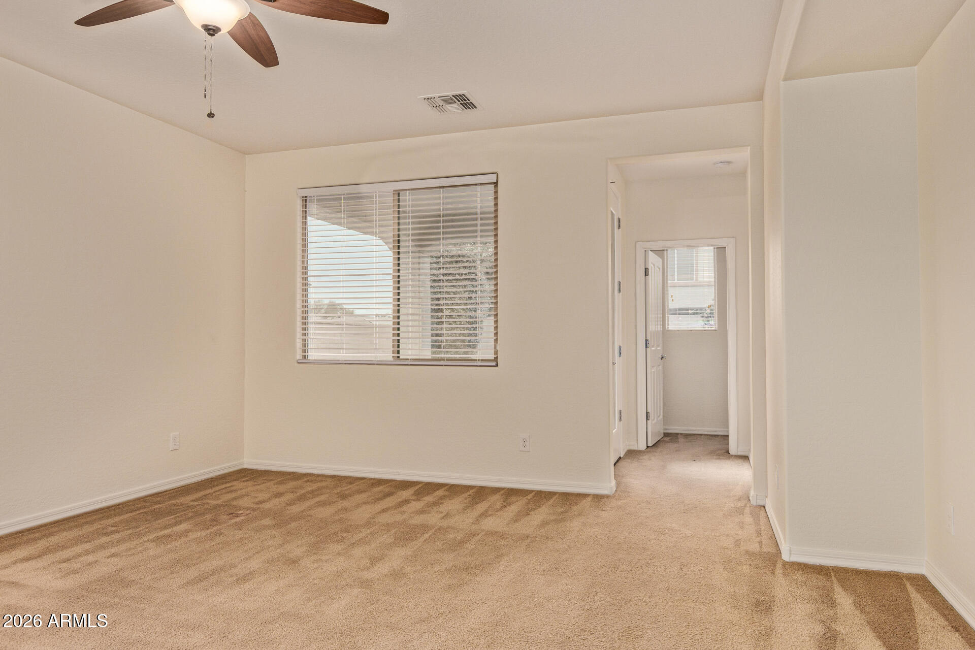 41334 West Rio Bravo Drive Maricopa, AZ 85138 - Photo 10 of 43 a view of an empty room with a window