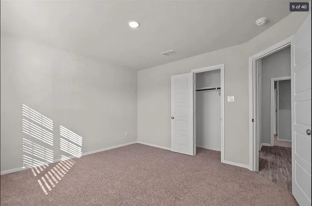 a view of an empty room and closet area