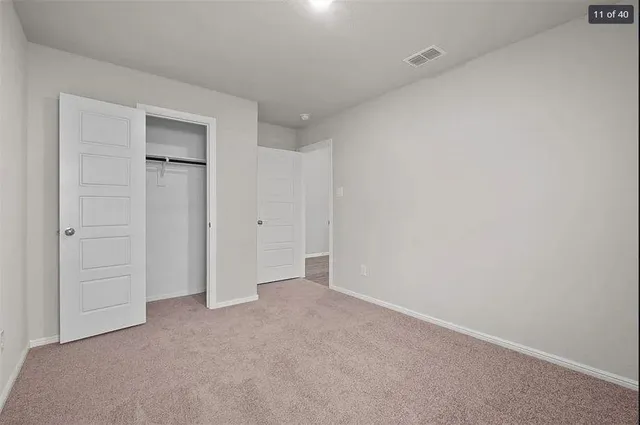 a view of an empty room and closet area
