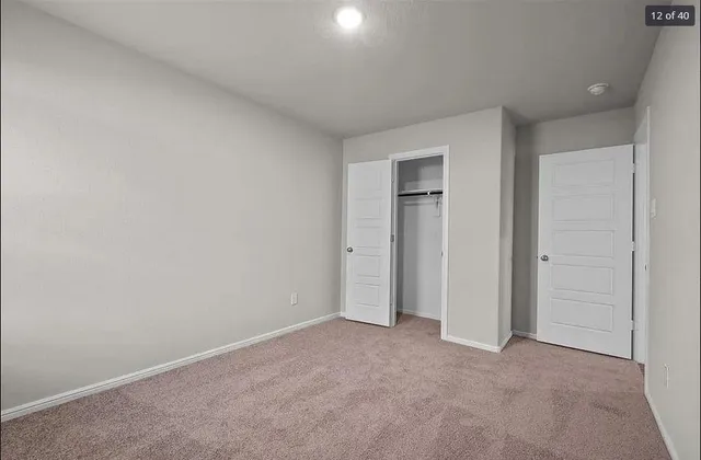an empty room with closet area