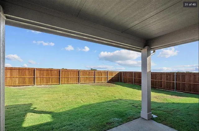 a view of a house with a yard and a garden