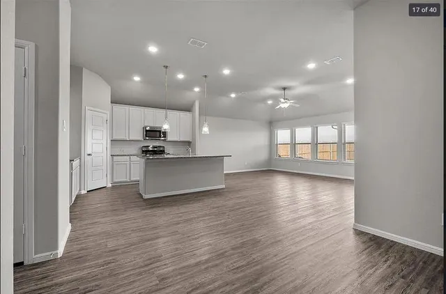 a view of kitchen with stove and wooden floor