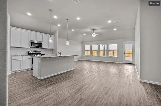 a view of kitchen with microwave and cabinets