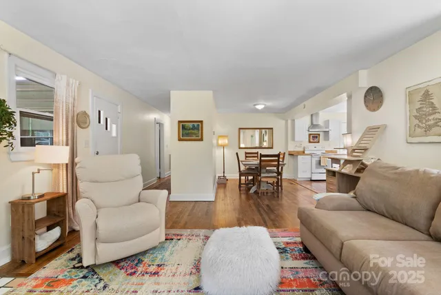 a living room with furniture and wooden floor