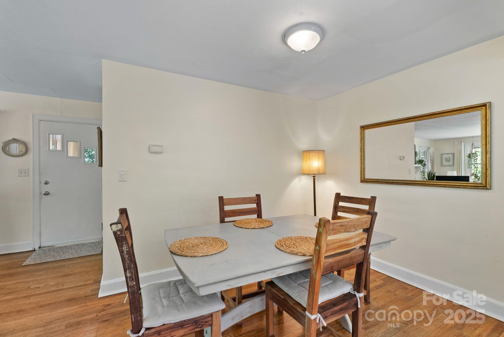 1215 Upper Brush Creek Road Fairview, NC 28730 - Photo 12 of 41 a dining room with furniture and wooden floor