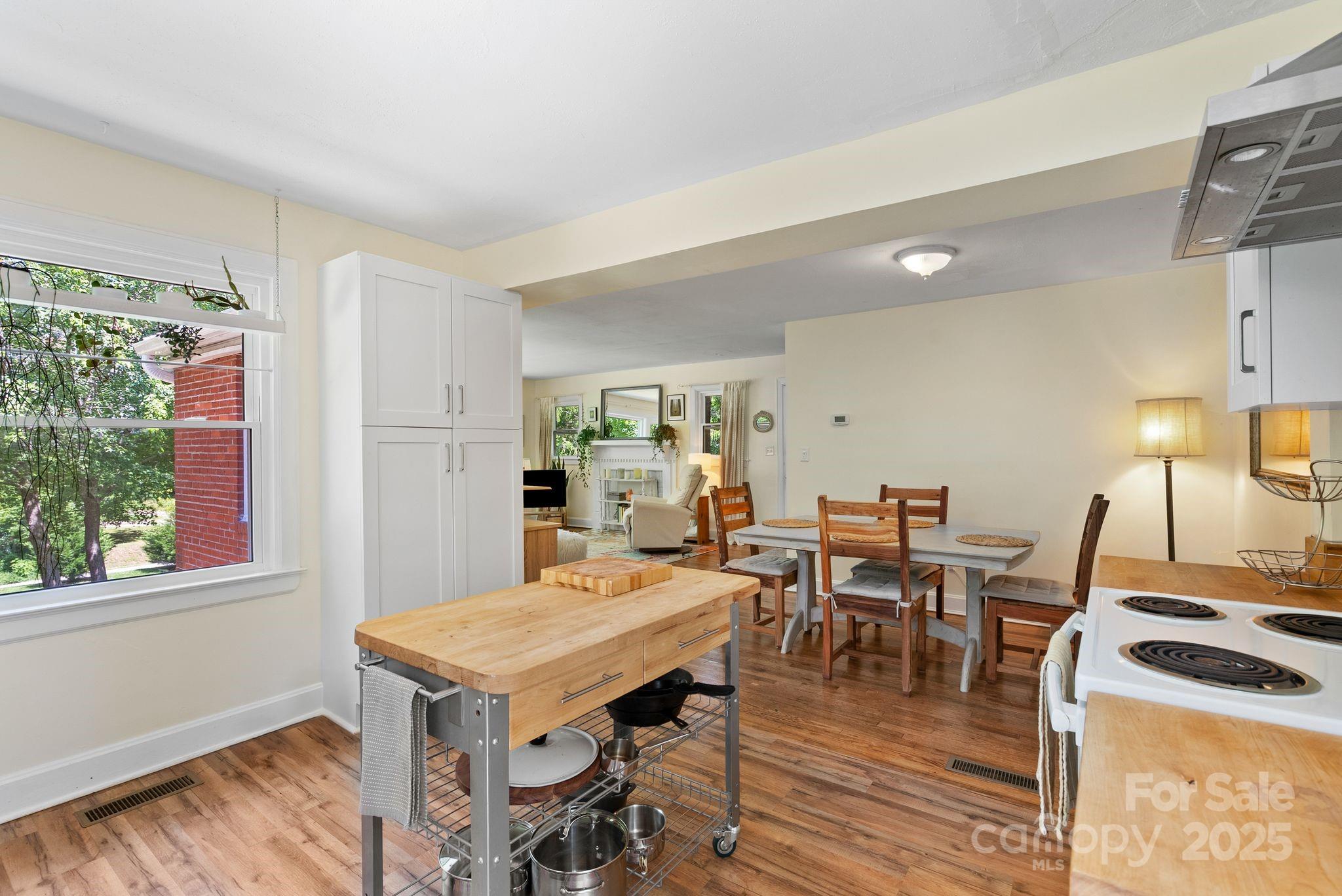 1215 Upper Brush Creek Road Fairview, NC 28730 - Photo 13 of 41 a view of a dining room with furniture window and wooden floor