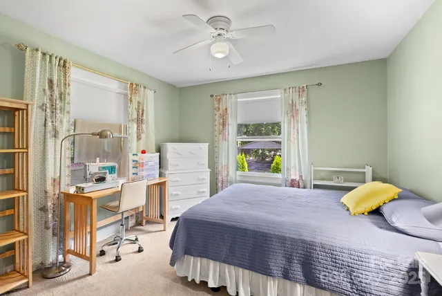 a bedroom with a bed dresser and a window