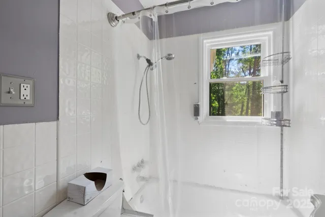 a bathroom with a bathtub and shower