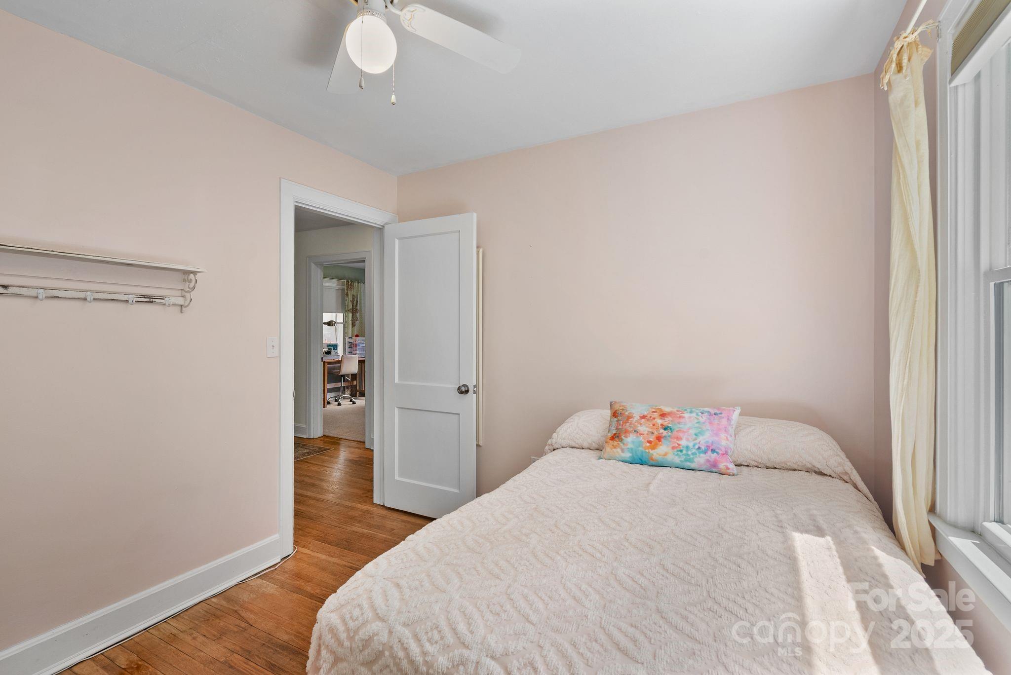 1215 Upper Brush Creek Road Fairview, NC 28730 - Photo 23 of 41 a bedroom with a bed and wooden floor
