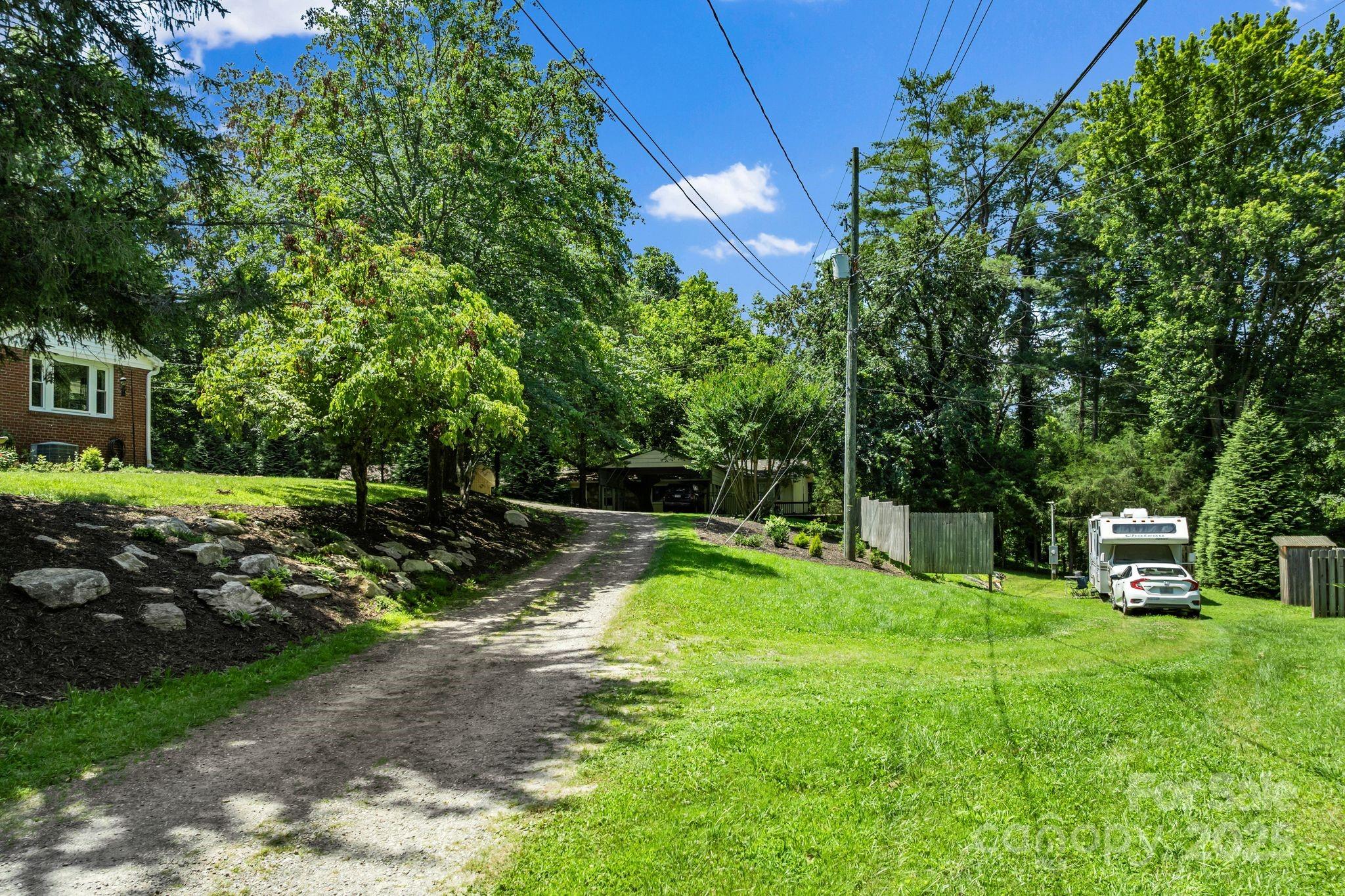 1215 Upper Brush Creek Road Fairview, NC 28730 - Photo 35 of 41 a view of a backyard with sitting area