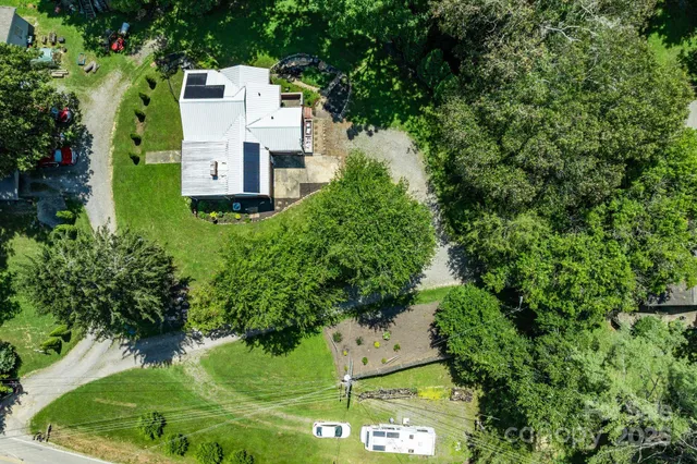 an aerial view of a house with a yard