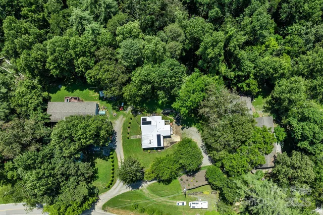 an aerial view of a house with a yard