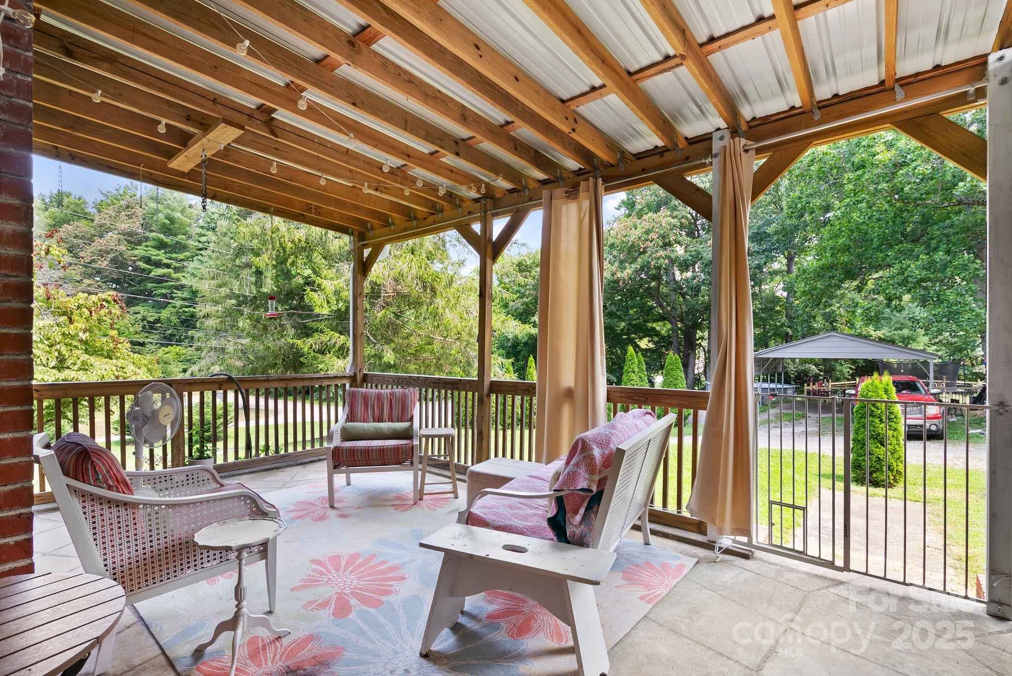 1215 Upper Brush Creek Road Fairview, NC 28730 - Photo 7 of 41 a view of a chair and table in the porch