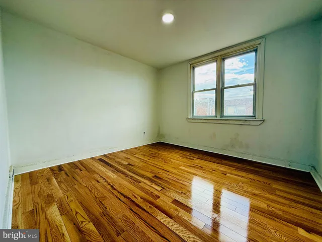 a kitchen with a sink cabinets and wooden floor