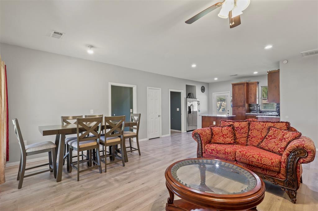 1556 John Wayne Road Kaufman, TX 75142 - Photo 7 of 33 a living room with furniture a dining table and kitchen view