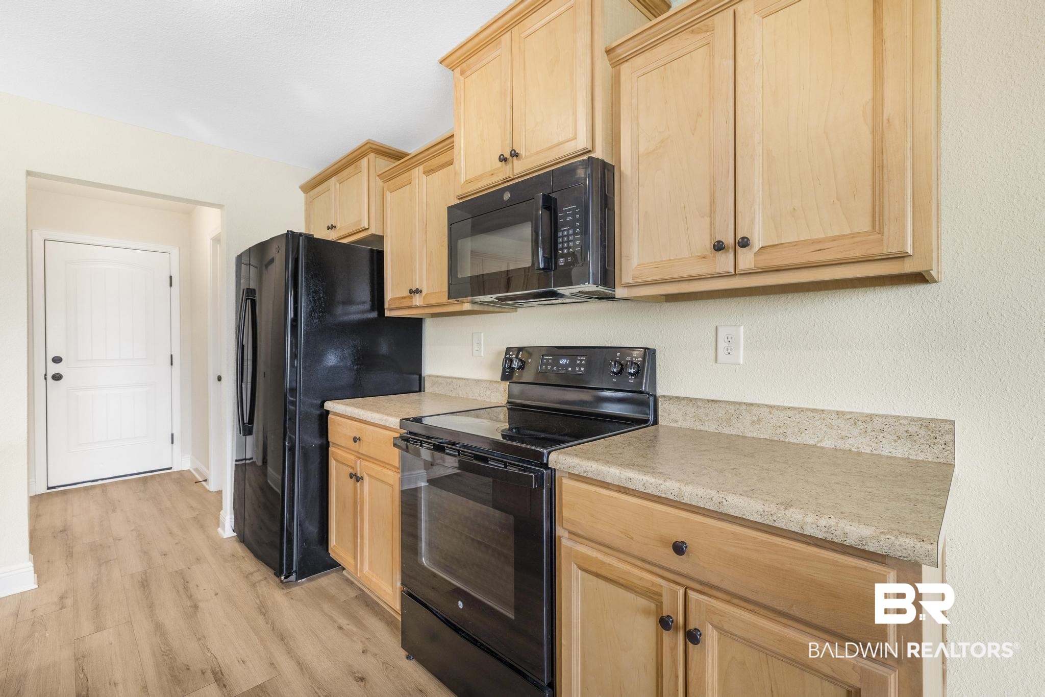 21580 Talbot Lane Robertsdale, AL 36567 - Photo 13 of 25 Kitchen featuring light brown cabinetry, black appliances, light countertops, and light wood finished floors