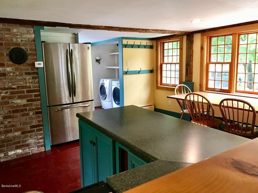117 Colrain Stage Road Heath, MA 01346 - Photo 8 of 41 a kitchen with stainless steel appliances granite countertop a refrigerator a stove and a sink with wooden floor