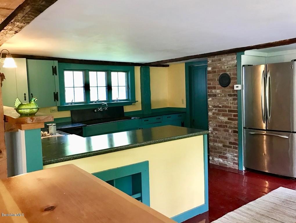 117 Colrain Stage Road Heath, MA 01346 - Photo 9 of 41 a kitchen with a refrigerator and a view of living room