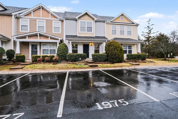 a front view of a residential apartment building with a yard