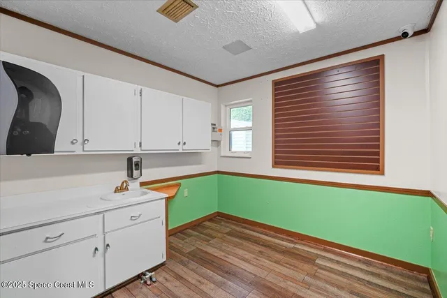 a view of a room with window wooden floor and a ceiling fan