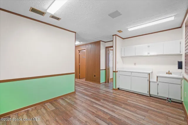 a view of a room with window and a wooden floor