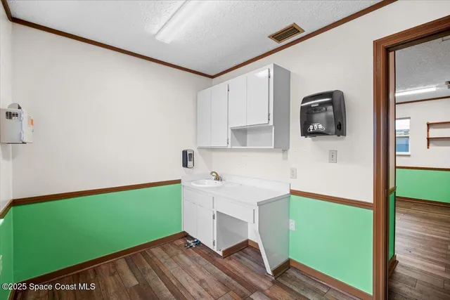 a kitchen with a sink and cabinets