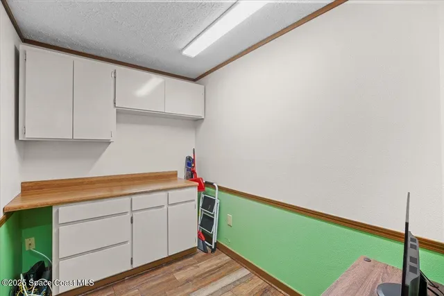 a view of a bedroom with workspace and a window