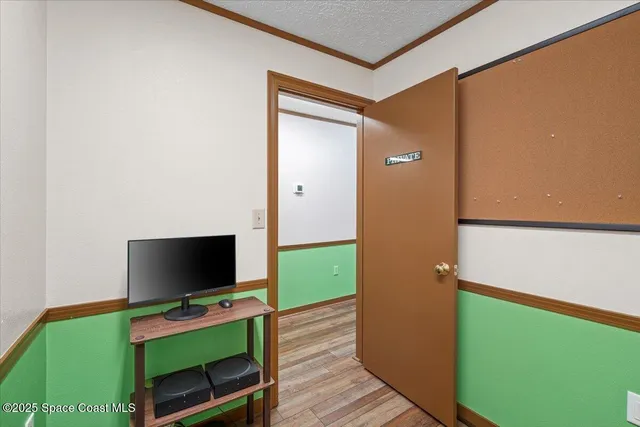 a room with green walls and stairs