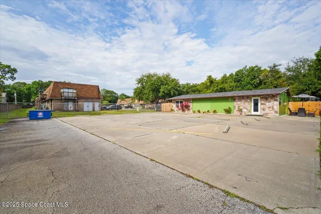 an aerial view of a house with yard and garage