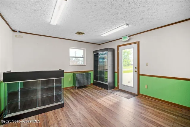 a room with lots of wooden furniture and a window