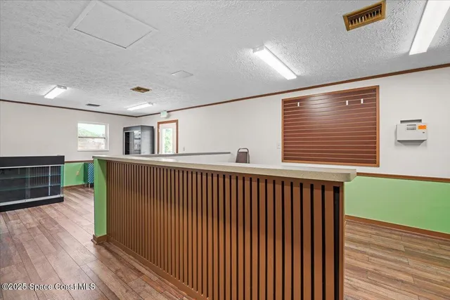 a living room with furniture and a baby crib